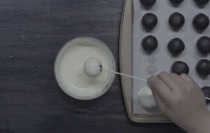 dip oreo balls into the white chocolate